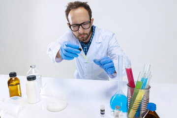 Portrait of young scientist, chemist or doctor conducts chemical research at pharmaceutical lab. Concept of chemistry, medicine.