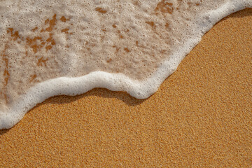 Fototapeta na wymiar white waves on the sand