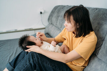 Obraz na płótnie Canvas Young mother is breastfeeding newborn baby
