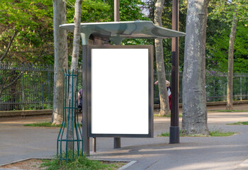 Bus stop billboard Mockup in empty street in Paris. Parisian hoarding advertisement close to a park...