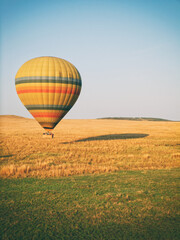 Vintage photography style of hot air Balloon for tourist in Maasai Mara National park, Kenya, selected focus.