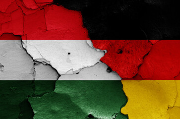 flags of Hungary and Germany painted on cracked wall