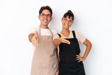 Restaurant mixed race waiters isolated on white background shaking hands for closing a good deal