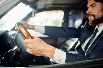 bearded man in a suit in a car a trip to work success service rich