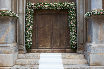 entrance to a church with floral decorations for weddings