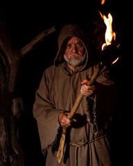 Angry poor farmer with torch in the middle ages