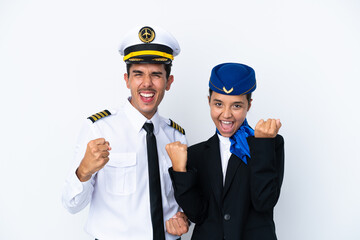 Airplane pilot and mixed race air hostess isolated on white background celebrating a victory