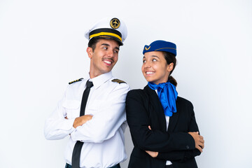 Airplane pilot and mixed race air hostess isolated on white background looking over the shoulder...