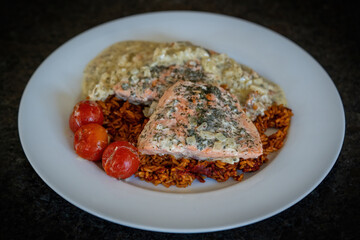 healthy and ready to eat - grilled salmon fillet with rice in onion creme sauce and cherry tomatoes