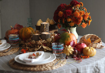 Fototapeta na wymiar Festive autumn table setting with pumpkin