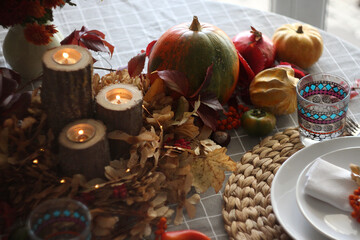 Obraz na płótnie Canvas Festive autumn table setting with pumpkin