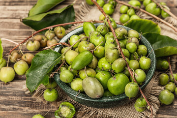 Harvest of ripe Actinidia arguta kiwi in a ceramic bowl