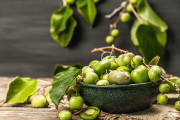 Harvest of ripe Actinidia arguta kiwi in a ceramic bowl