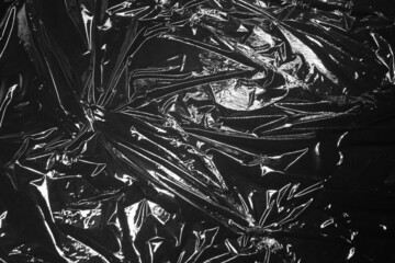 Reflecting light and shadow on creases and folds in black plastic sheeting