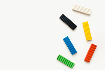 Colored plasticine on a white background. Pieces of plasticine. 