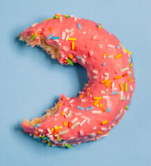 Strawberry donut with bitten colored shavings