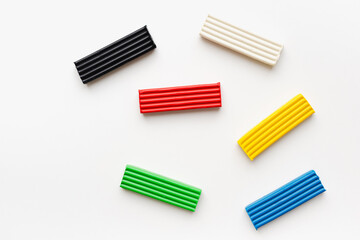Colored plasticine on a white background. Pieces of plasticine. 