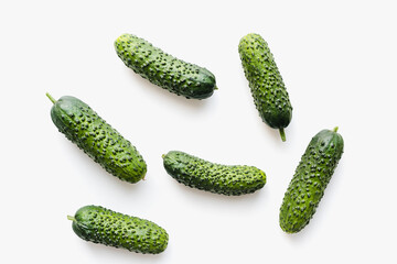 Green cucumbers on a white background. Pimpled cucumbers. 