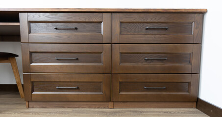 Wooden dresser with drowers in minimalist room interior