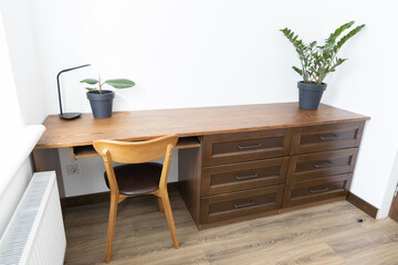 Wooden dresser with drowers in minimalist room interior
