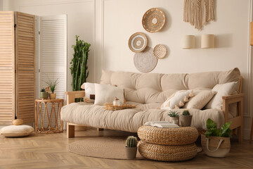 Stylish living room interior with comfortable wooden sofa and beautiful houseplants