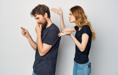 cheerful young couple with a phone in hand emotions Studio Lifestyle