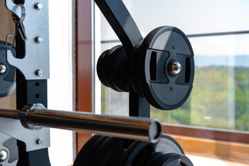 Weight plate on metal barbell in a gym