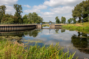 Fototapeta na wymiar The beautiful flowing river called 'the Berkel' in the Achterhoek landscape, taken at a lock in the province of Gelderland 