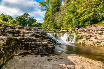 A long exposure view of the lower falls at Stainforth Force, Yorkshire in summertime