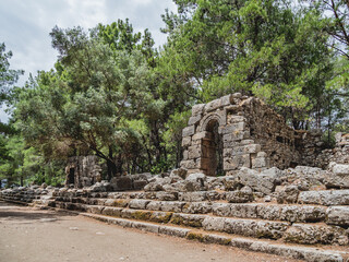 Fototapeta na wymiar Ruins of ancient city Phaselis. Stones of damaged buildings. Agora of Domitian. Turkey.