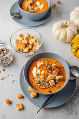 Vegetarian autumn pumpkin soup with cream, seeds and toasts. Autumn and winter healthy food concept.