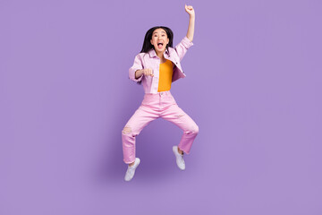 Full body photo of hooray millennial brunette lady jump wear jacket jeans sneakers isolated on violet background