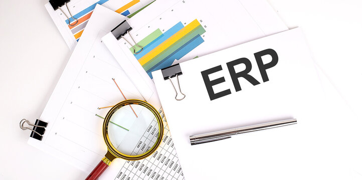 ERP text on white paper on the light background with charts paper