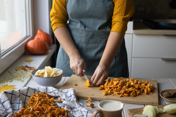 Middle-aged woman cooking traditional Finnish Mushroom Chanterelle soup. 