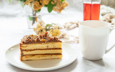 tea with piece of sponge cake decorated with chocolate served for breakfast in the morning at home or in a hotel, enjoying life and yummy food concept.