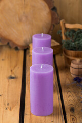 Three lilac interior candles in a wooden room
