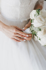 bride in white dress holding bouquet wedding day