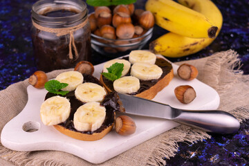 Chocolate spread with banana on bread. Close-up.