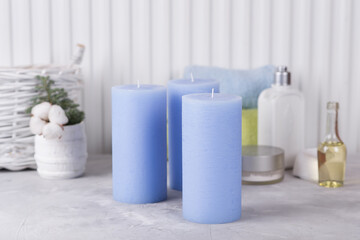 Blue candles in the bathroom. Terry towel wadded pads.