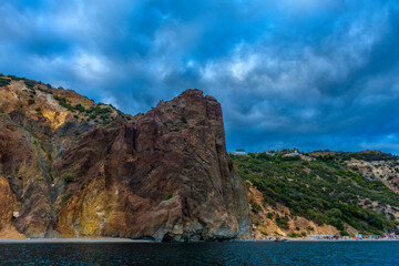 rocks of Cape Fiolent against the background of the evening sky with clouds