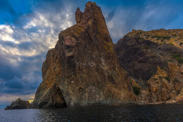 rocks of Cape Fiolent against the background of the evening sky with clouds