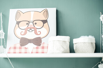 A white shelf on the wall with a picture of a gopher with glasses and a mustache, with baskets for small things on a gray background.