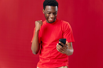 Cropped view of cheerful african man with phone in hands