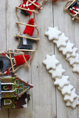 Festive Christmas background. Small elves in red hats and cookies in the shape of hexagonal stars.