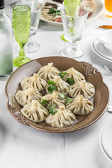 Georgian dumplings Khinkali with meat on brown plate on the table