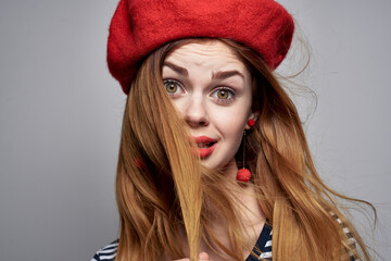 beautiful woman in a striped t-shirt red lips gesture with his hands lifestyle