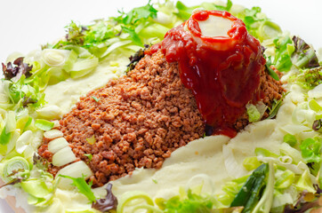 Minced meat formed in the shape of a foot, topped with a tomato sauce, a creative way of serving food for Halloween