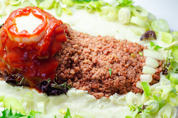 Minced meat formed in the shape of a foot, topped with a tomato sauce, a creative way of serving food for Halloween