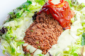 Minced meat formed in the shape of a foot, topped with a tomato sauce, a creative way of serving food for Halloween