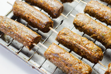 Minced and shaped lamb kebabs with chilli and coriander prepared for grill
